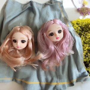 Amazing mismatched sad eye doll heads pink/peach haired face fish hook earrings